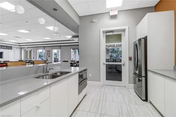 a kitchen with stainless steel appliances granite countertop a refrigerator and a sink