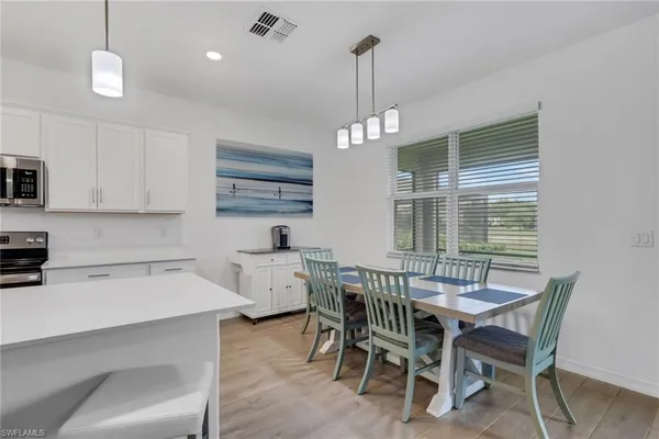 a view of a dining room with furniture window and wooden floor