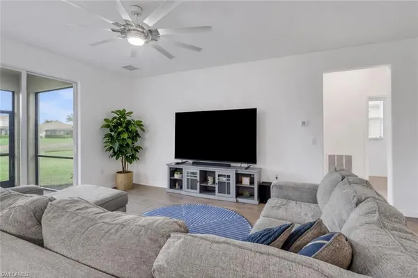 a living room with furniture and a flat screen tv
