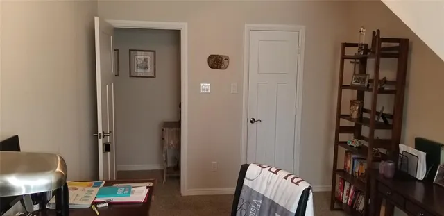 a view of a hallway with couch and closet