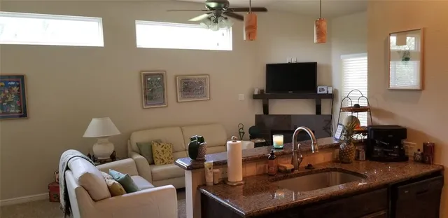 a kitchen with a sink a stove and a microwave