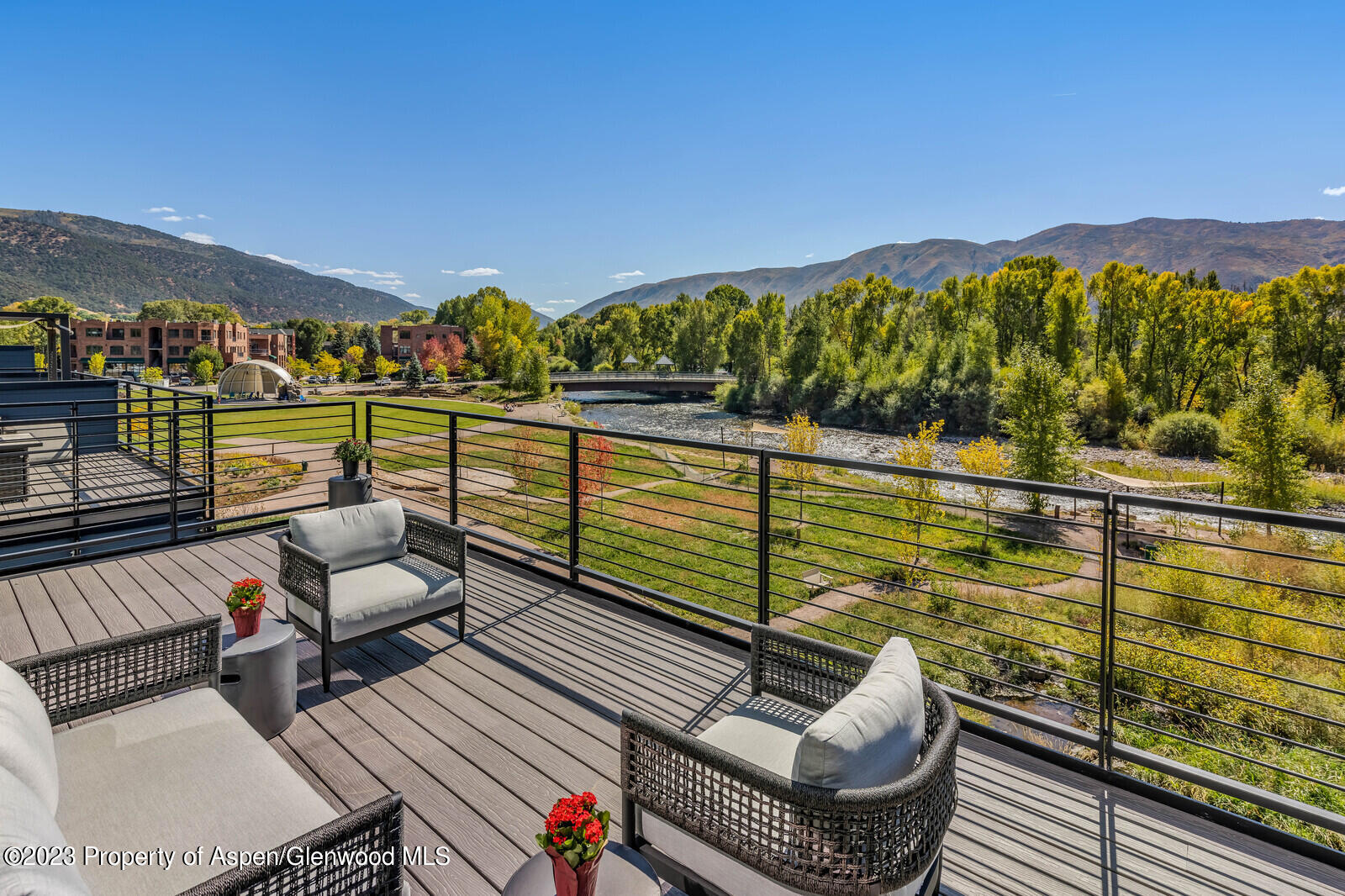 a view of a chairs and table on the balcony