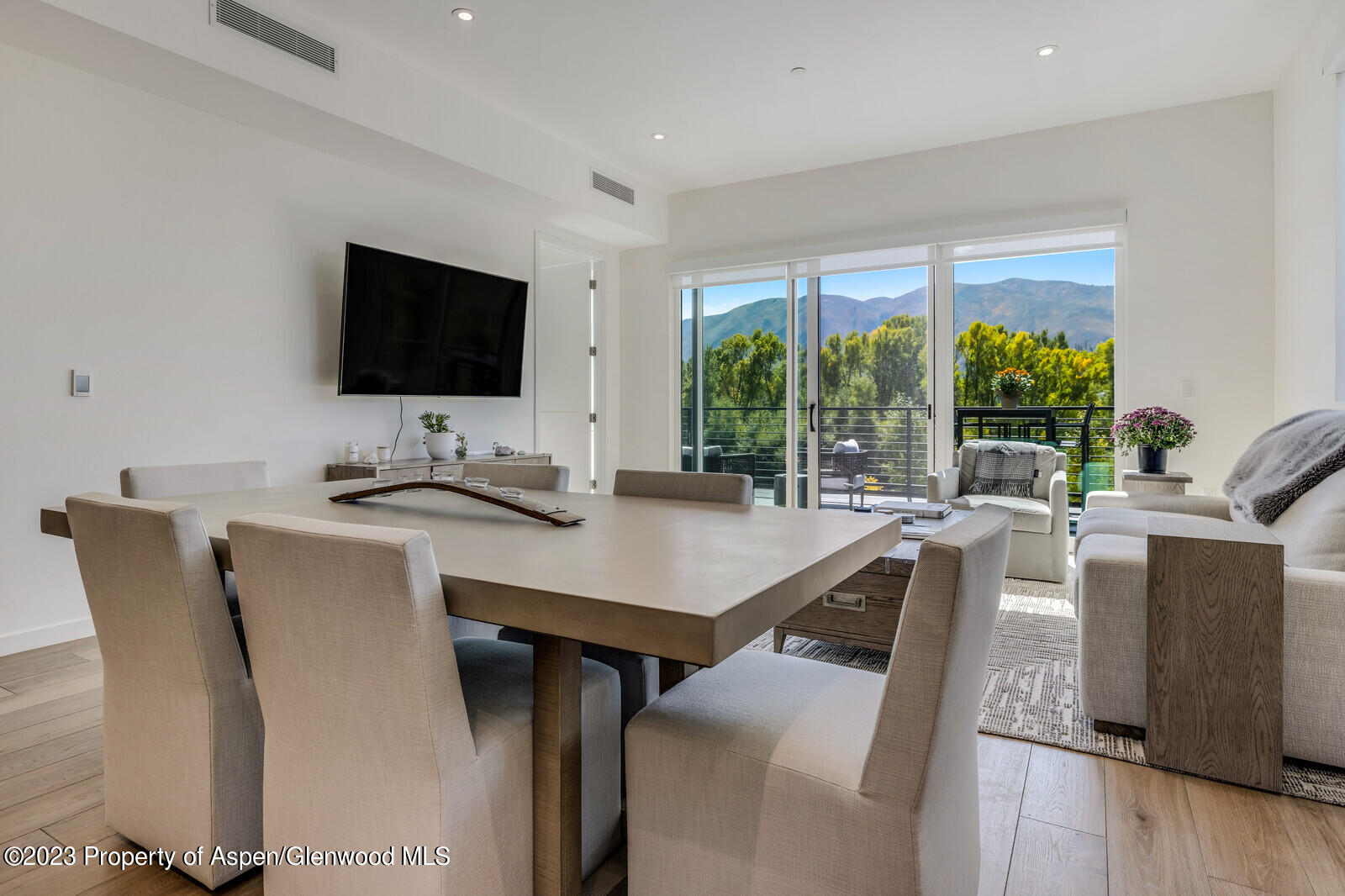 22860 2 Rivers Road, Unit 370 Basalt, CO 81621 - Photo 4 of 27 a work room with furniture a large window and a flat screen tv