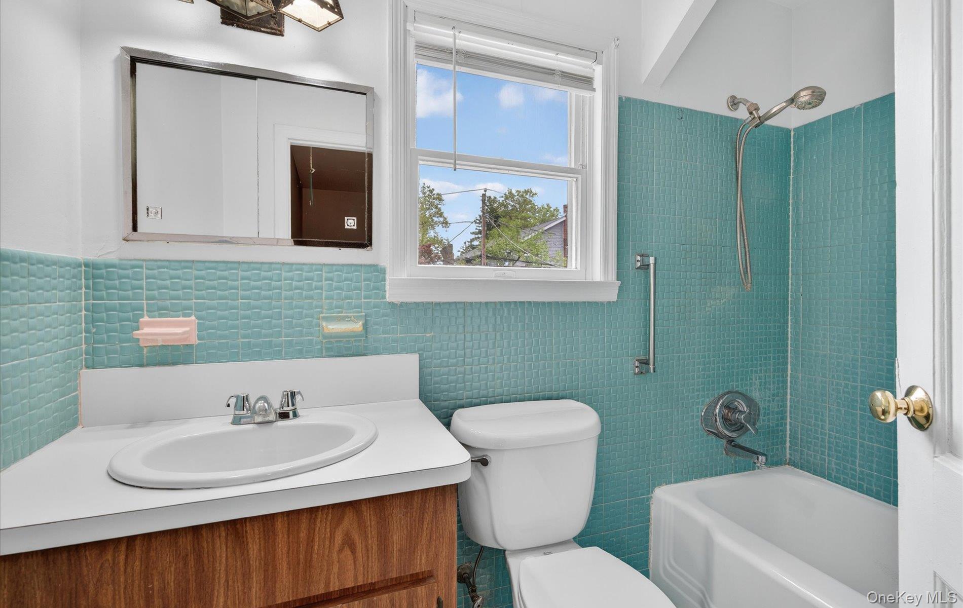 24 Purdue Road Glen Cove, NY 11542 - Photo 31 of 41 a bathroom with a sink a toilet and mirror