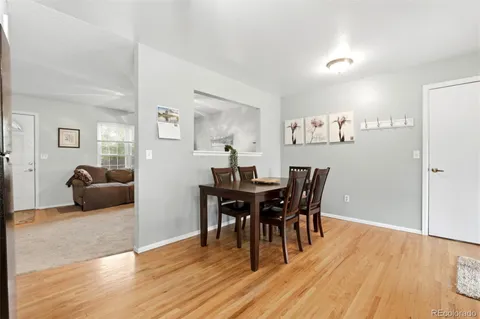 a view of a dining room with furniture and wooden floor