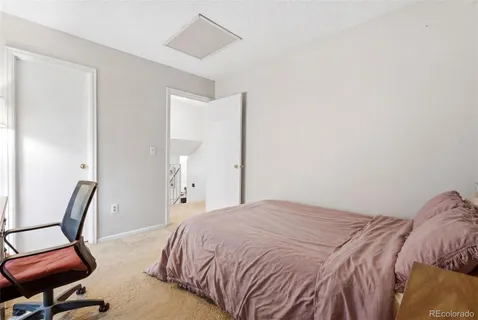 a bedroom with a bed and chair