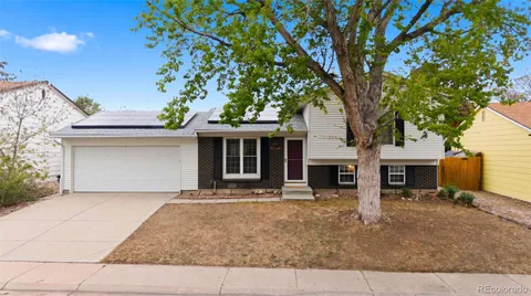 front view of a house with a tree