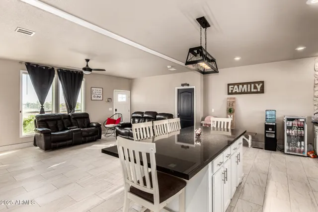a living room with furniture and a ceiling fan
