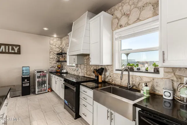 a kitchen with a sink stove and cabinets