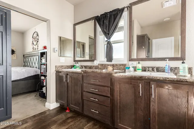 a en suite bathroom with a sink a mirror and a bathtub
