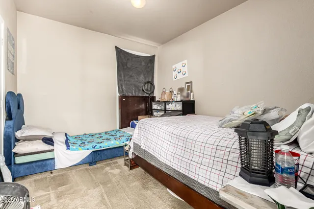 a bedroom with a bed and a mirror