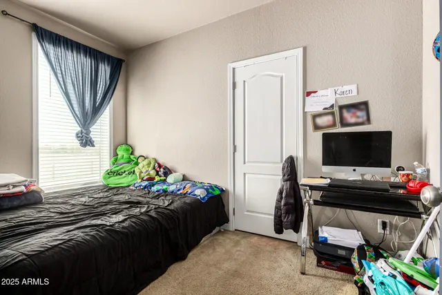 a bedroom with a bed and flat screen tv