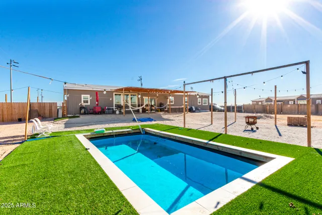 a view of a backyard with a swimming pool