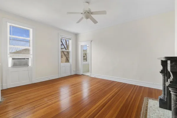 wooden floor in an empty room with a window