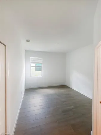 an empty room with a empty space and windows