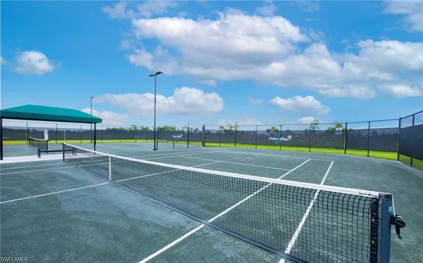 a view of a patio with chairs and table under an umbrella