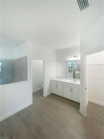 a room with a mirror and a view of bathroom