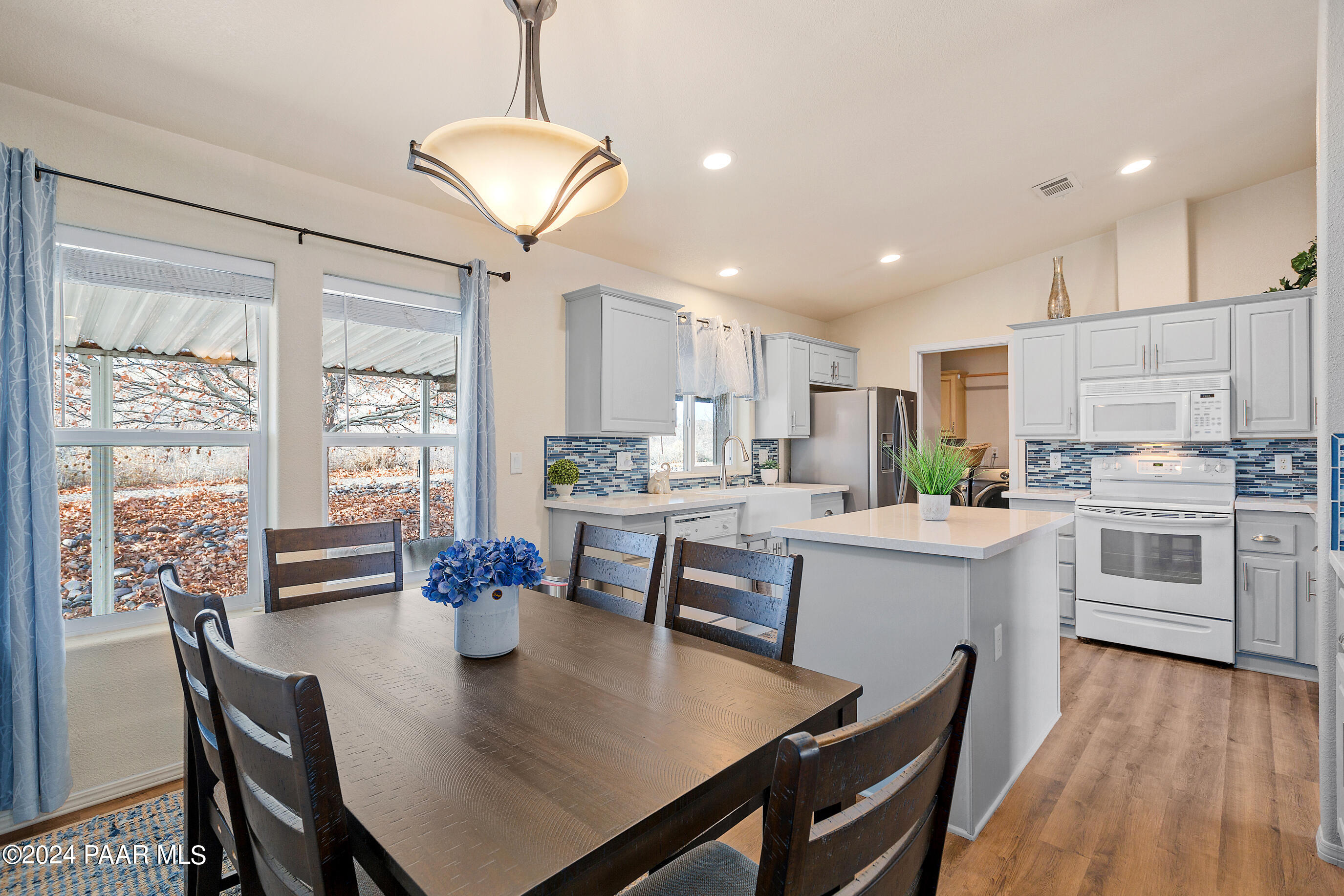 11250 East State Rte 69 Dewey, AZ 86327 - Photo 2 of 38 a kitchen with stainless steel appliances granite countertop a stove refrigerator dining table and chairs