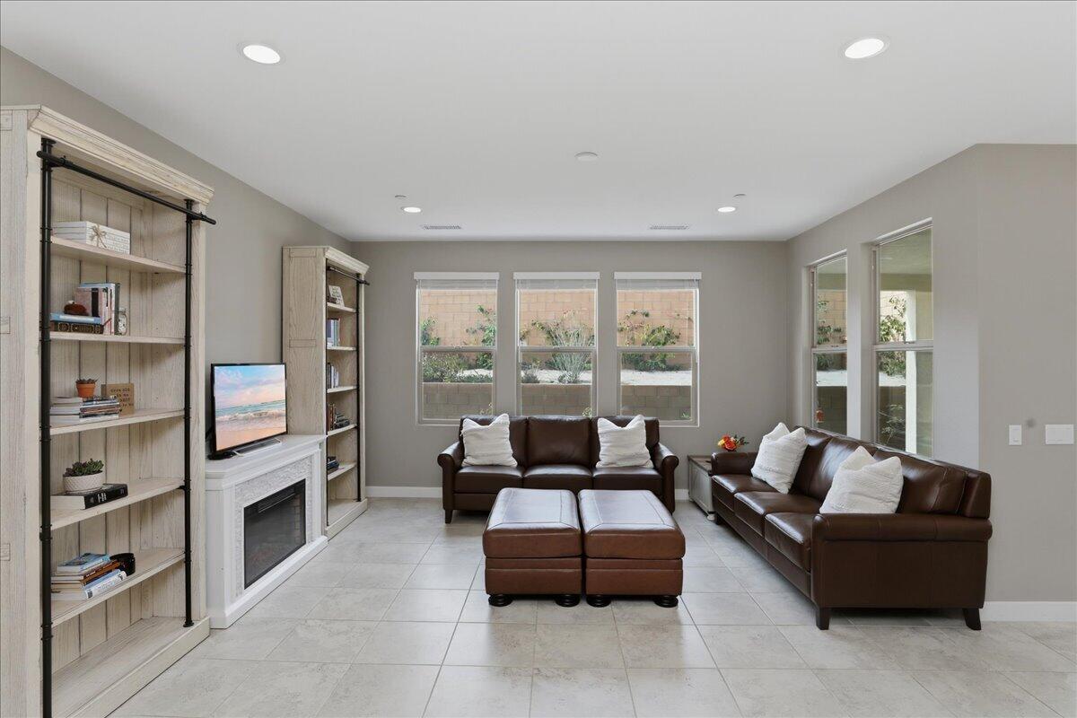 73721 Raphael Drive Palm Desert, CA 92211 - Photo 11 of 54 a living room with furniture wooden floor and a fireplace