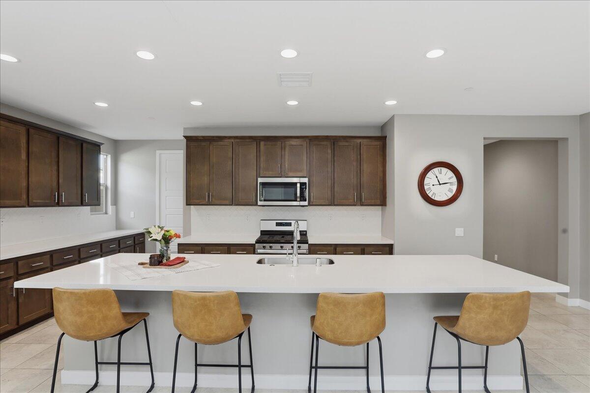 73721 Raphael Drive Palm Desert, CA 92211 - Photo 15 of 54 a kitchen with stainless steel appliances granite countertop a sink and a white cabinets
