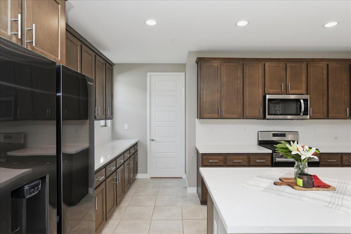73721 Raphael Drive Palm Desert, CA 92211 - Photo 18 of 54 a kitchen with stainless steel appliances granite countertop a refrigerator and a stove top oven