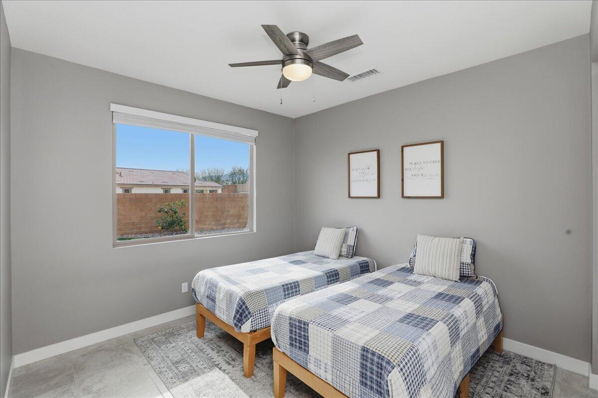 73721 Raphael Drive Palm Desert, CA 92211 - Photo 25 of 54 a bedroom with bed and window