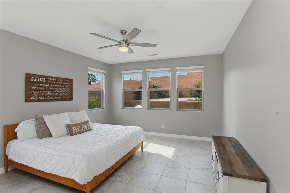 73721 Raphael Drive Palm Desert, CA 92211 - Photo 26 of 54 a bedroom with a bed and window