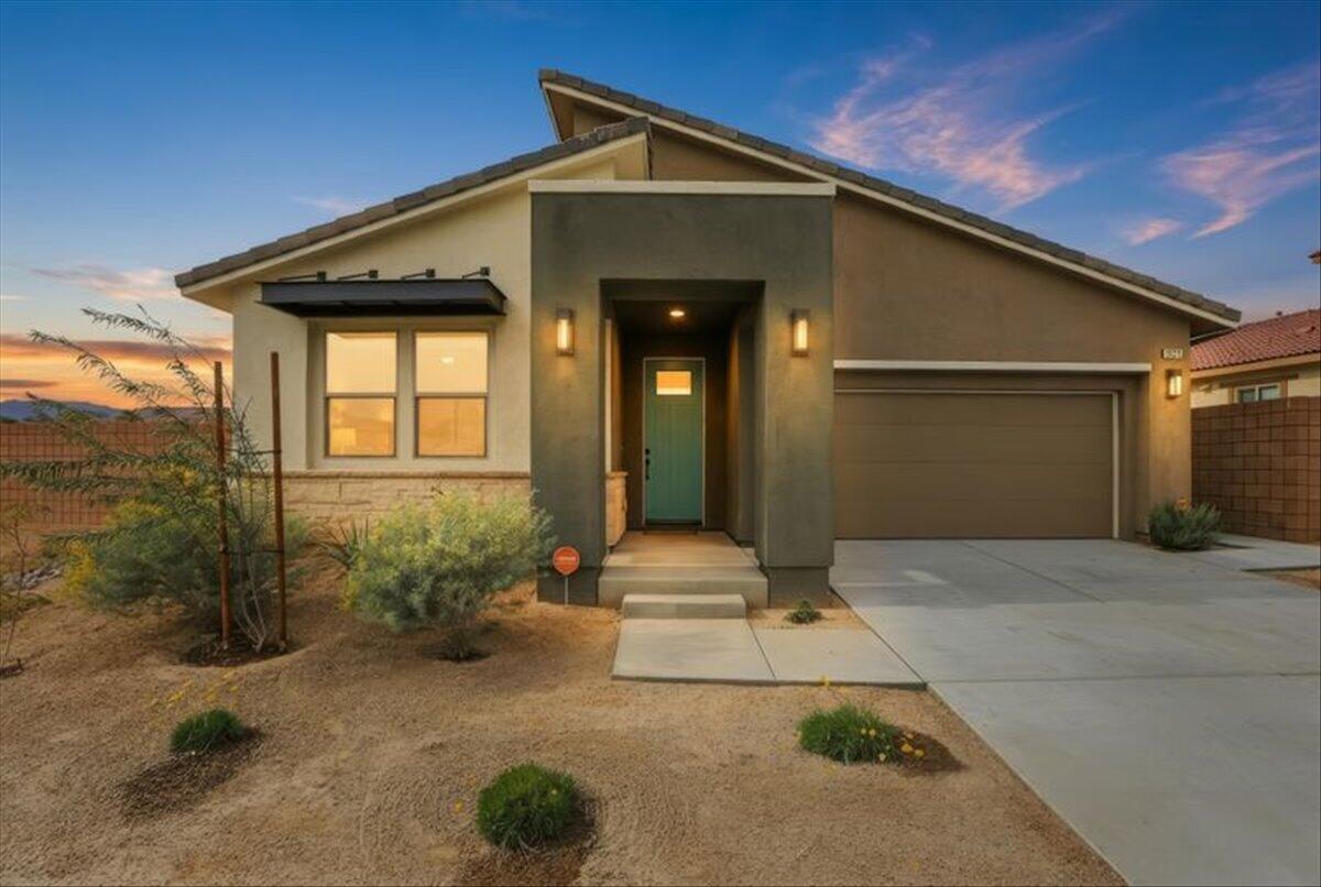 73721 Raphael Drive Palm Desert, CA 92211 - Photo 3 of 54 a front view of a house with garden