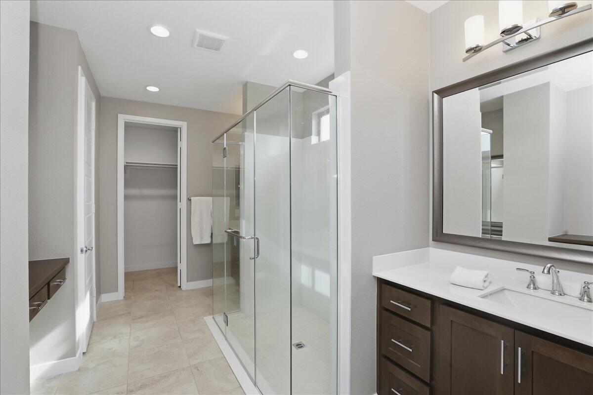 73721 Raphael Drive Palm Desert, CA 92211 - Photo 31 of 54 a bathroom with a double vanity sink mirror and shower