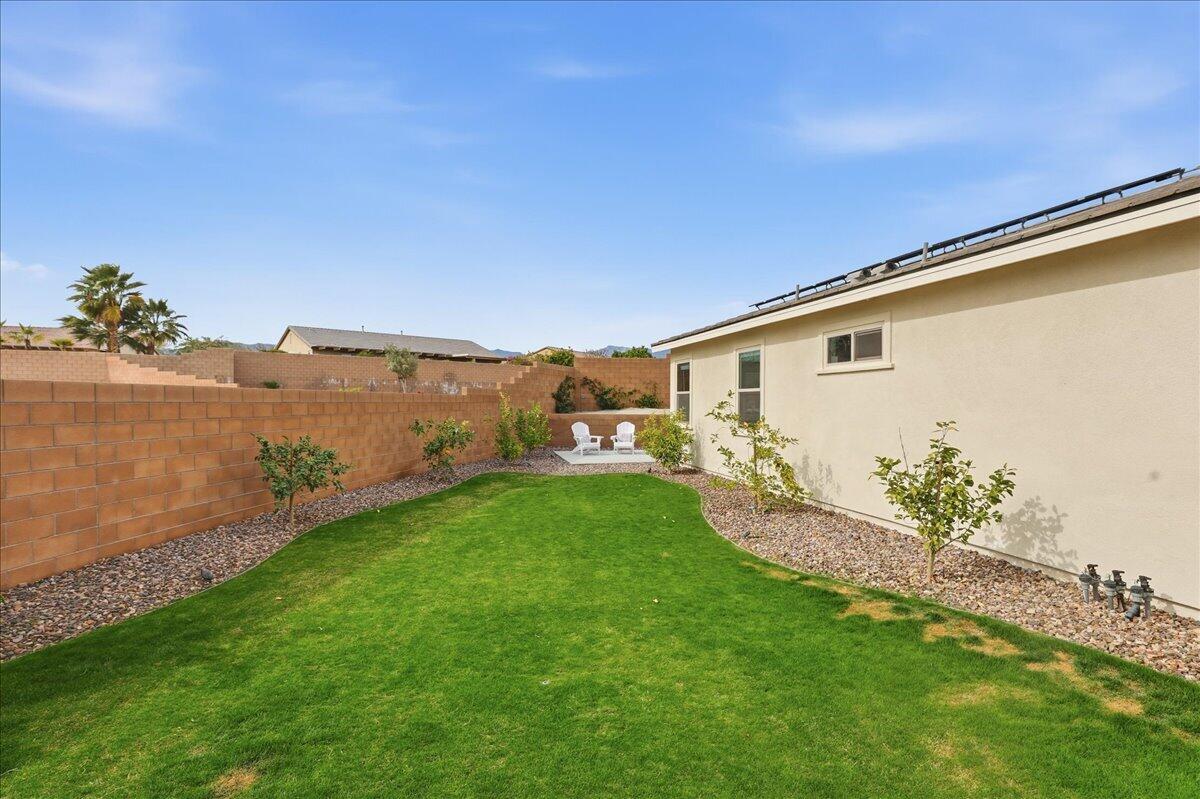 73721 Raphael Drive Palm Desert, CA 92211 - Photo 35 of 54 a backyard with potted plants and large tree