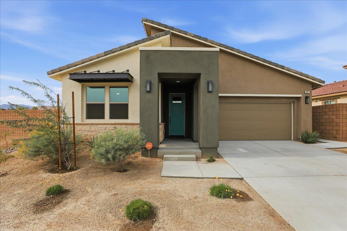 73721 Raphael Drive Palm Desert, CA 92211 - Photo 4 of 54 a front view of a house with garden