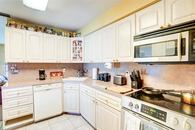a kitchen filled with stainless steel appliances cabinets and a sink