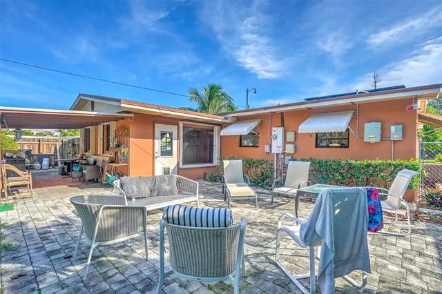 a view of backyard with outdoor seating and plants