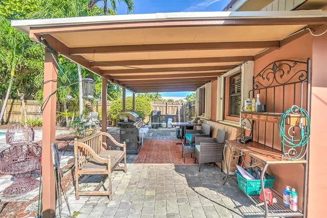 a view of a patio with a table chairs and a backyard