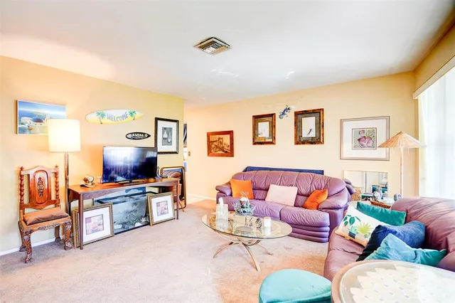a living room with furniture a rug and a flat screen tv