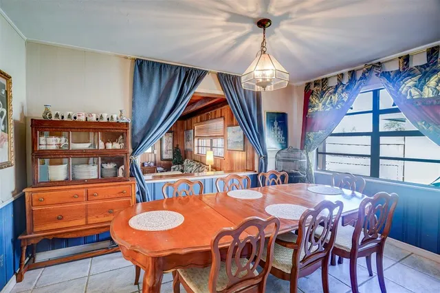 a view of a dining room with furniture a chandelier and wooden floor
