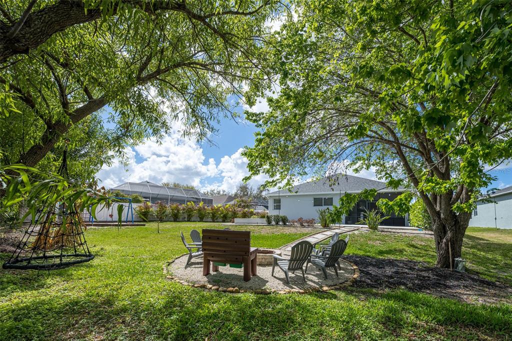 4136 Little Gap Loop Ellenton, FL 34222 - Photo 14 of 50 a view of a table and chairs in backyard of the house