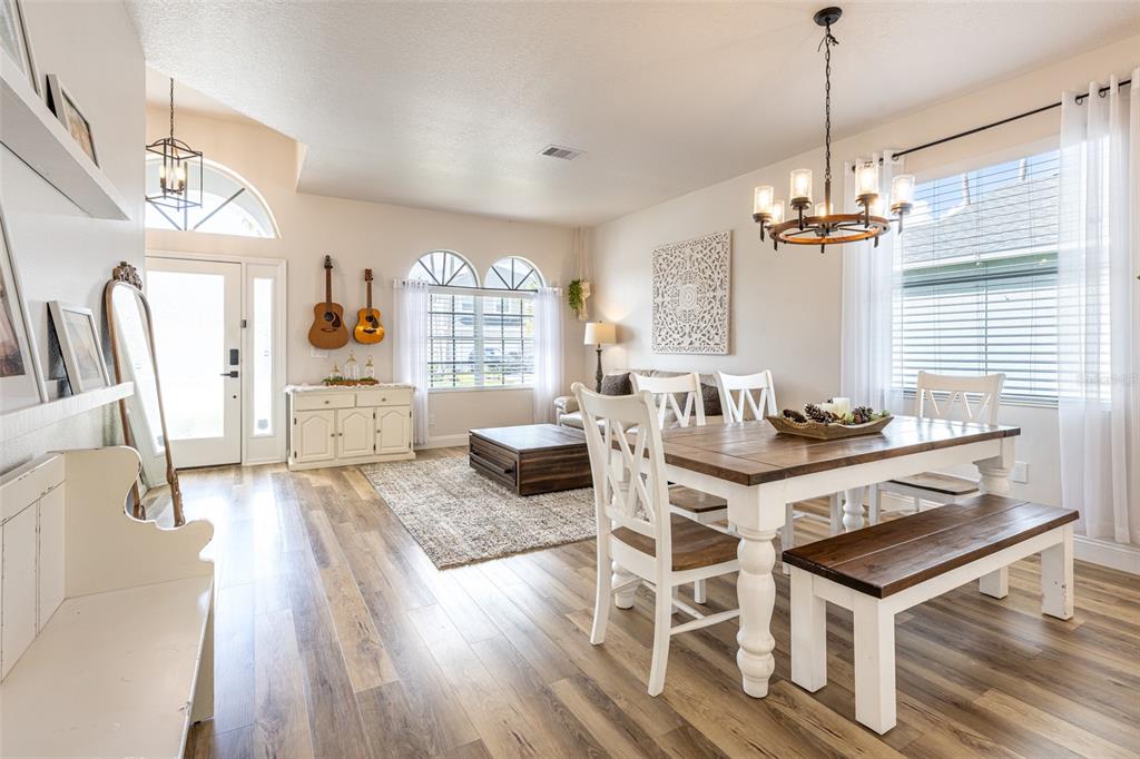 4136 Little Gap Loop Ellenton, FL 34222 - Photo 20 of 50 a living room with furniture a dining table and a fireplace