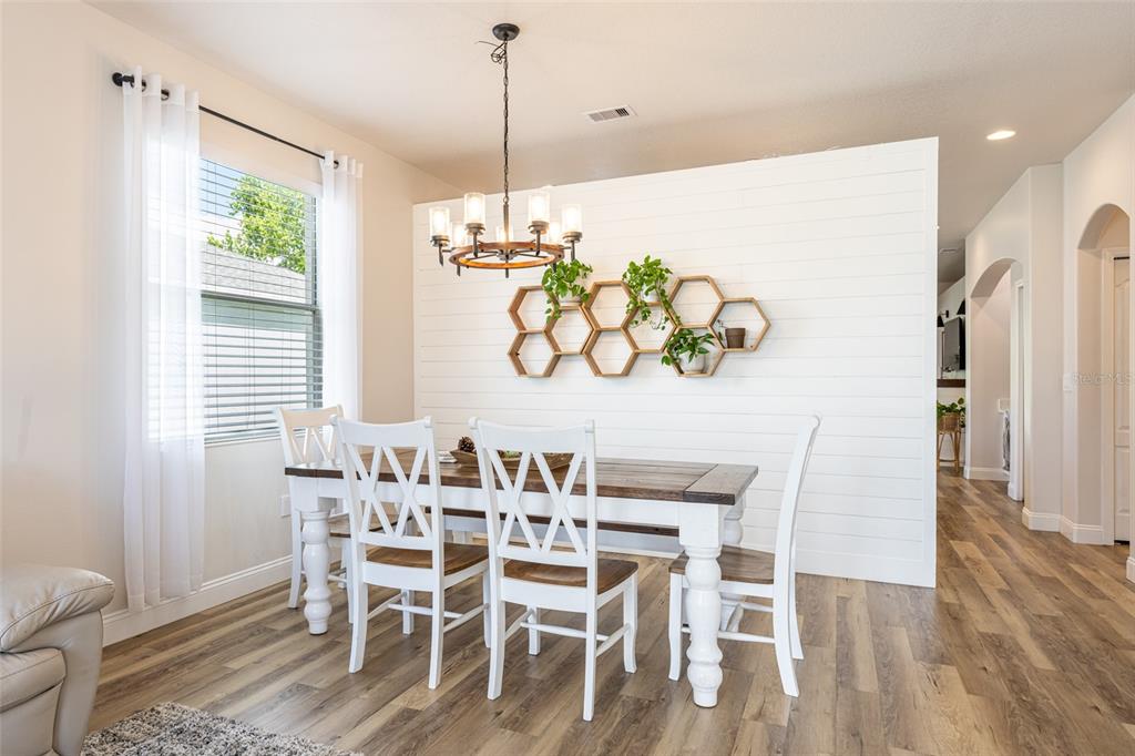 4136 Little Gap Loop Ellenton, FL 34222 - Photo 21 of 50 a view of a dining room with furniture window and wooden floor