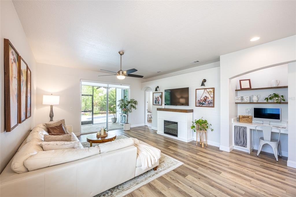 4136 Little Gap Loop Ellenton, FL 34222 - Photo 24 of 50 a living room with furniture a fireplace and a flat screen tv