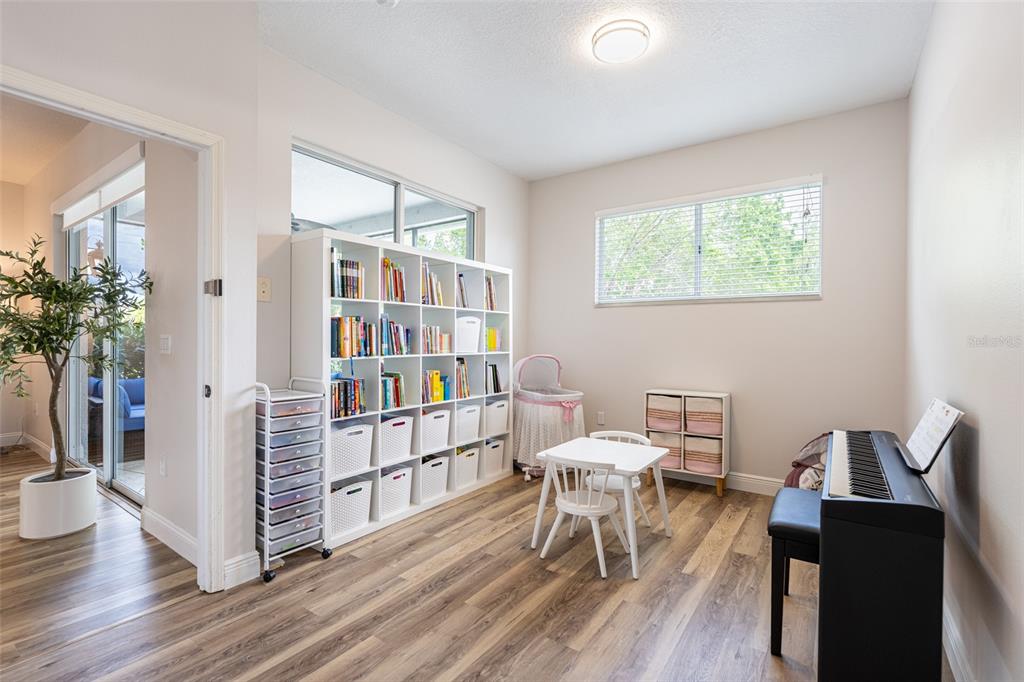 4136 Little Gap Loop Ellenton, FL 34222 - Photo 27 of 50 a view of a workspace with furniture and a book shelf
