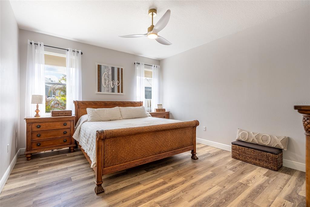 4136 Little Gap Loop Ellenton, FL 34222 - Photo 28 of 50 a bedroom with a bed and wooden floor