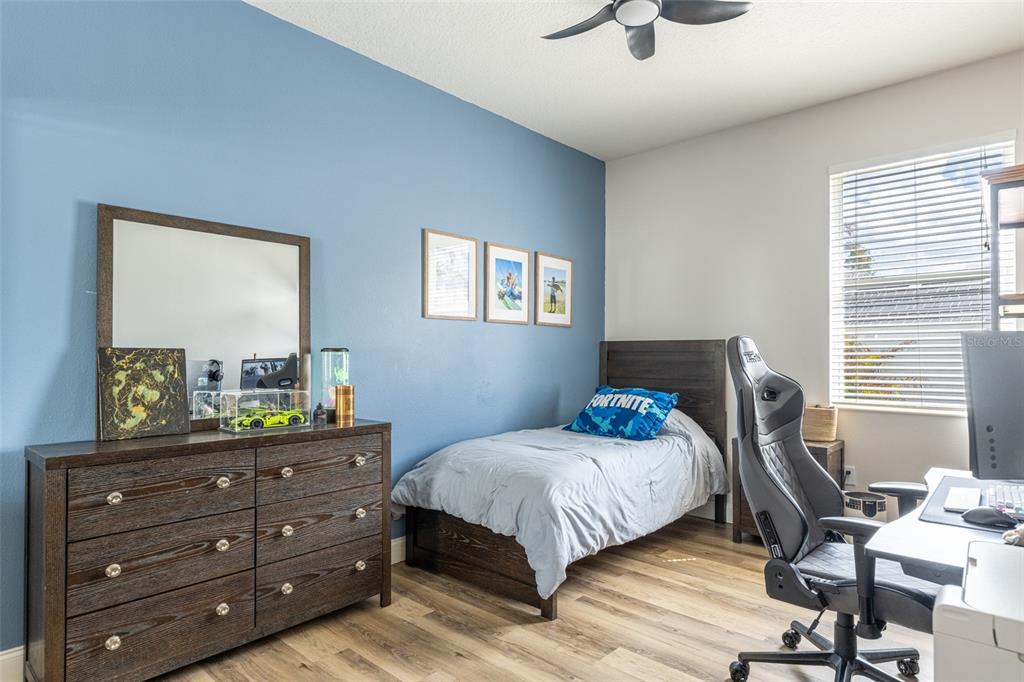 4136 Little Gap Loop Ellenton, FL 34222 - Photo 31 of 50 a bedroom with a bed and a dresser