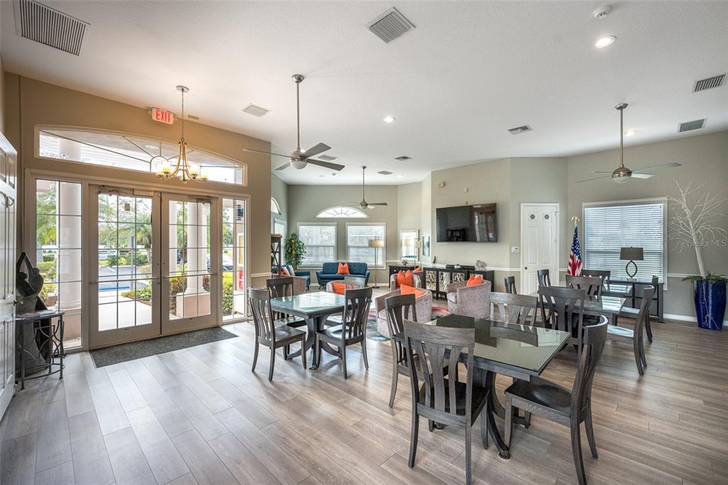 4136 Little Gap Loop Ellenton, FL 34222 - Photo 43 of 50 a view of a dining room and livingroom with furniture wooden floor a chandelier