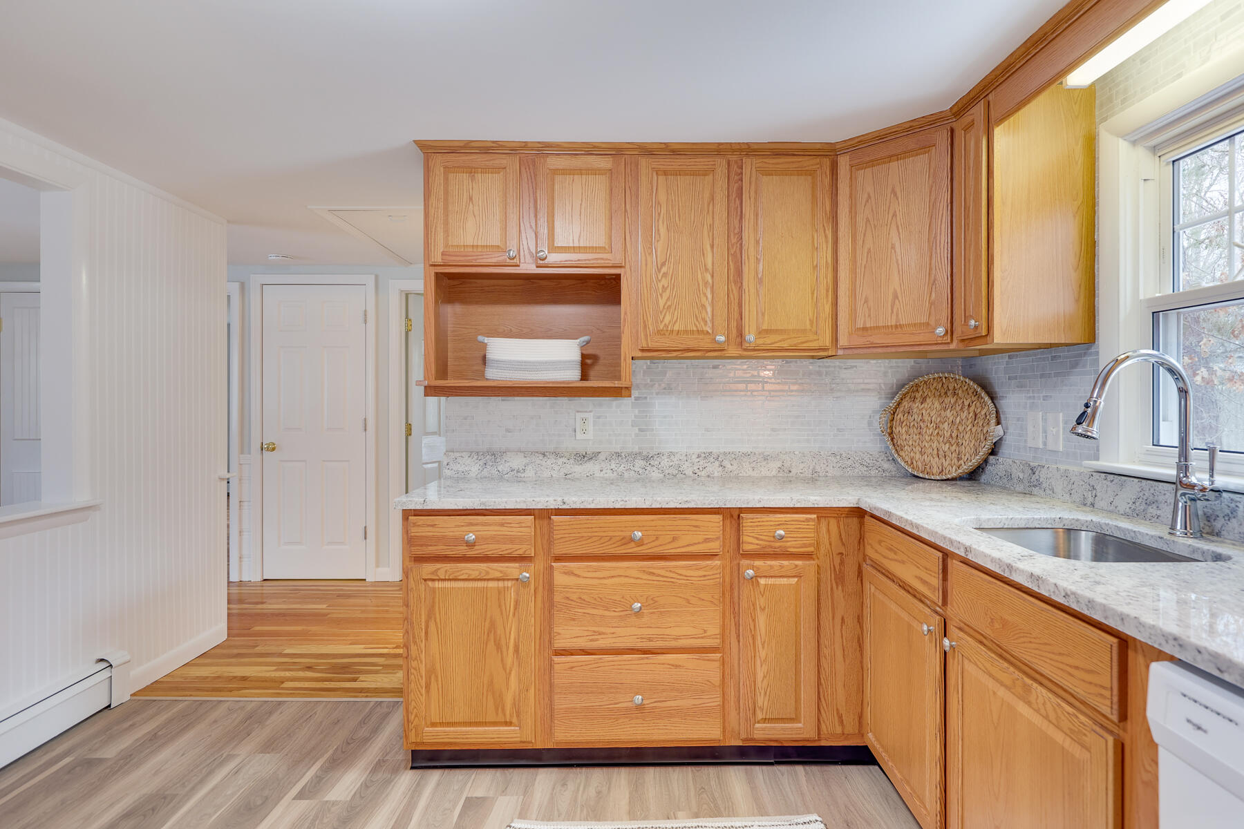 98 Long Road Harwich, MA 02645 - Photo 7 of 31 a kitchen with granite countertop wooden cabinets and a sink