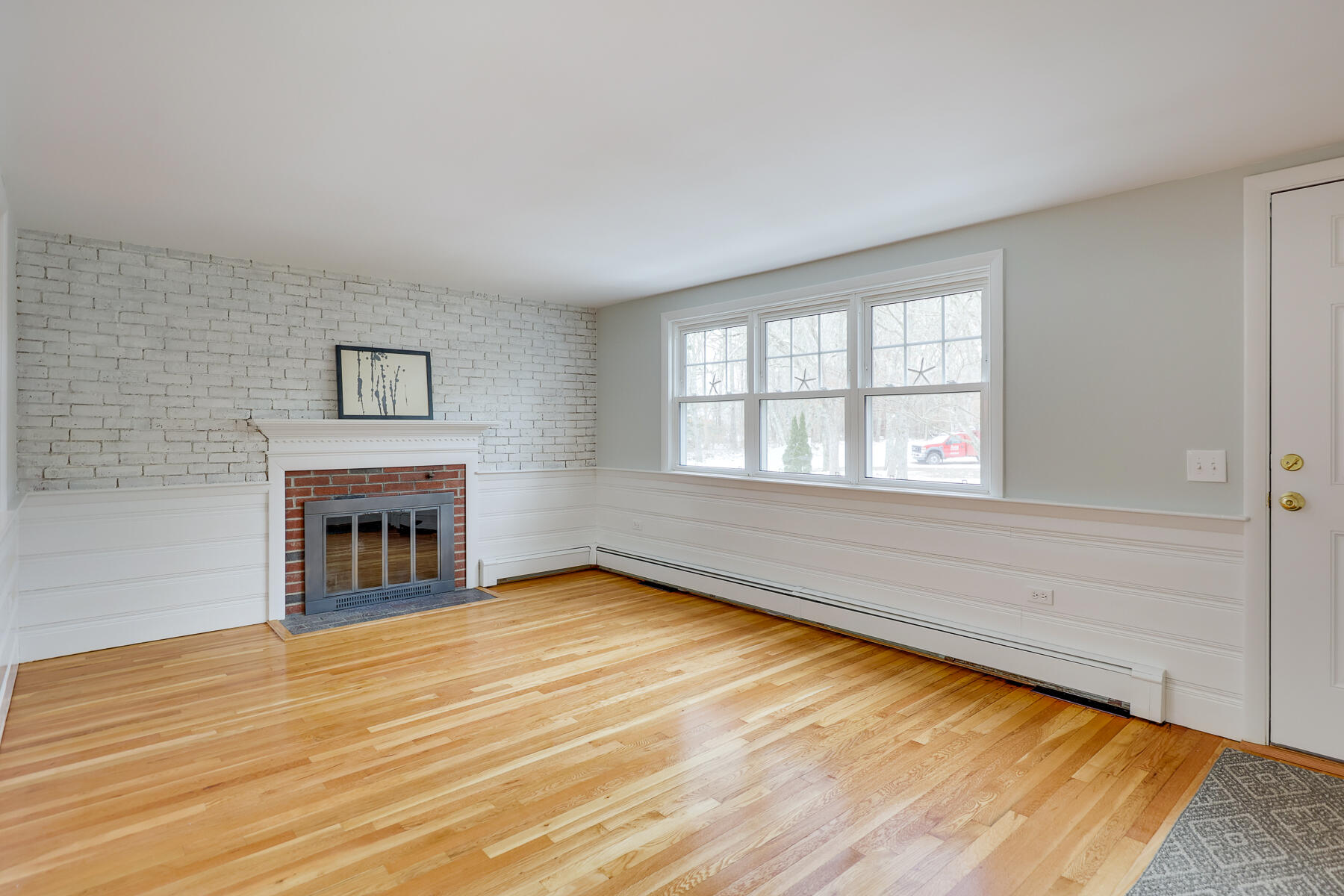98 Long Road Harwich, MA 02645 - Photo 9 of 31 a view of an empty room with a window and fireplace