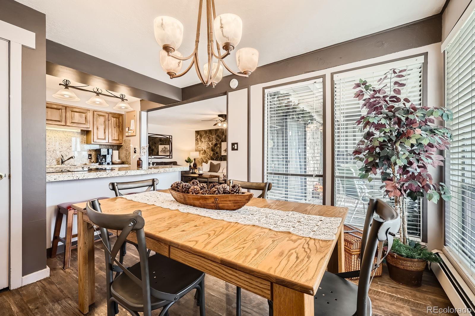 120 E Lane, Unit 109 Dillon, CO 80435 - Photo 15 of 39 a dining room with furniture a chandelier and wooden floor