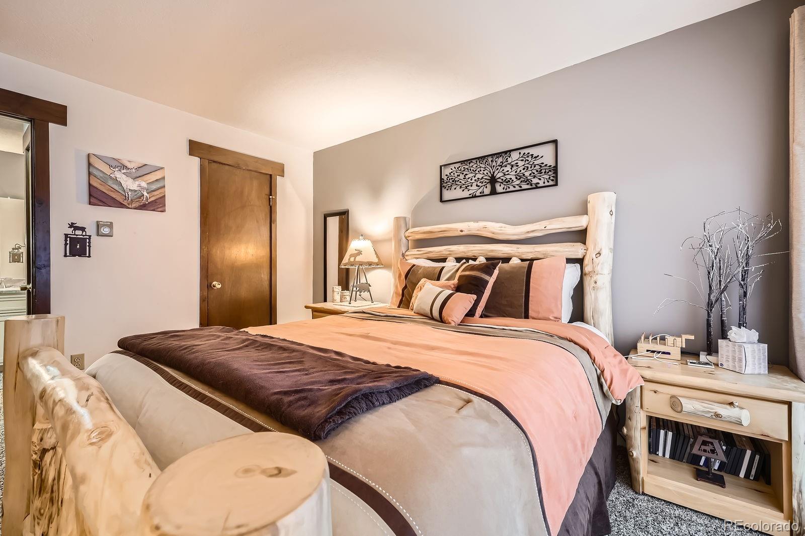 120 E Lane, Unit 109 Dillon, CO 80435 - Photo 18 of 39 a bedroom with a bed and a mirror