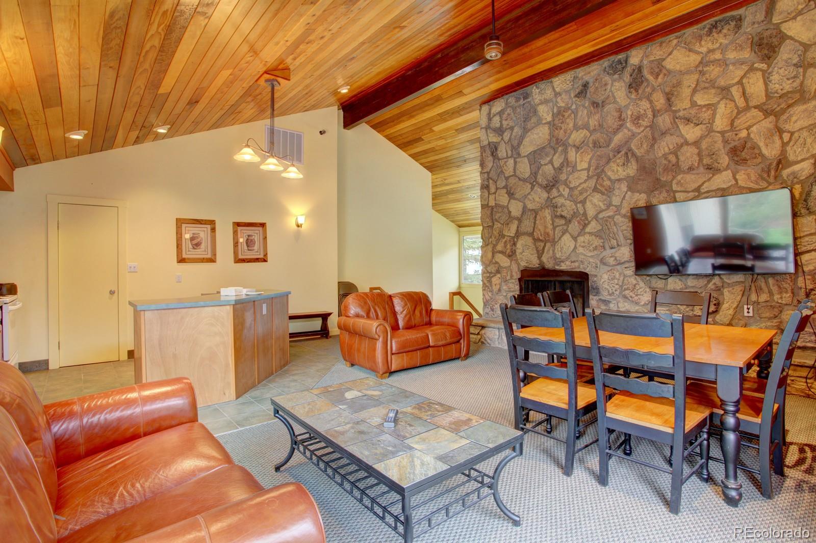 120 E Lane, Unit 109 Dillon, CO 80435 - Photo 36 of 39 a living room with furniture and a flat screen tv