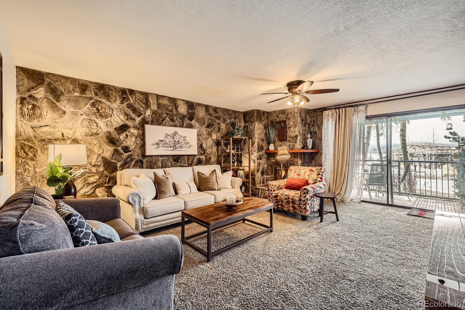 120 E Lane, Unit 109 Dillon, CO 80435 - Photo 8 of 39 a living room with furniture and a large window